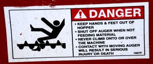 A warning decal for an auger. 