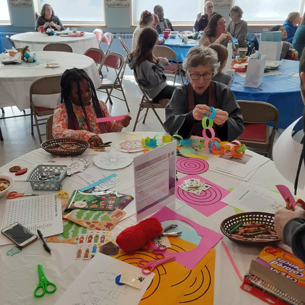 Children creating a paper chain for Bodhi/Buddha's Enlightenment Day presented by Susan Myoyu Anderson.