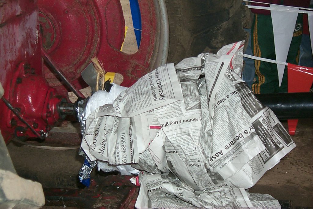 A power take off shaft wrapped in newspaper as part of a demonstration on power take-off safety.