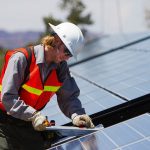 Man installing solar panel