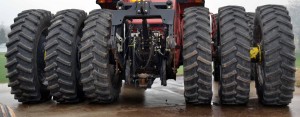 A color photo of a farm tractor with triple tires on rear axles. 