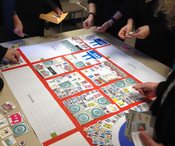 people playing a zoning board game