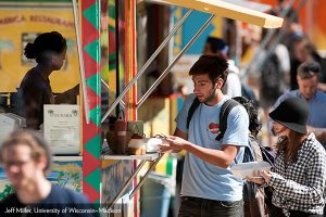 man buying food from a food cart