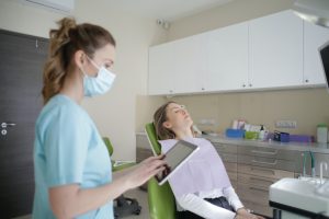 Dental assistant with patient