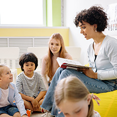 woman reading to a group of children