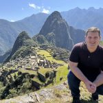 Adam Riley posing for a photo in the mountains of Peru