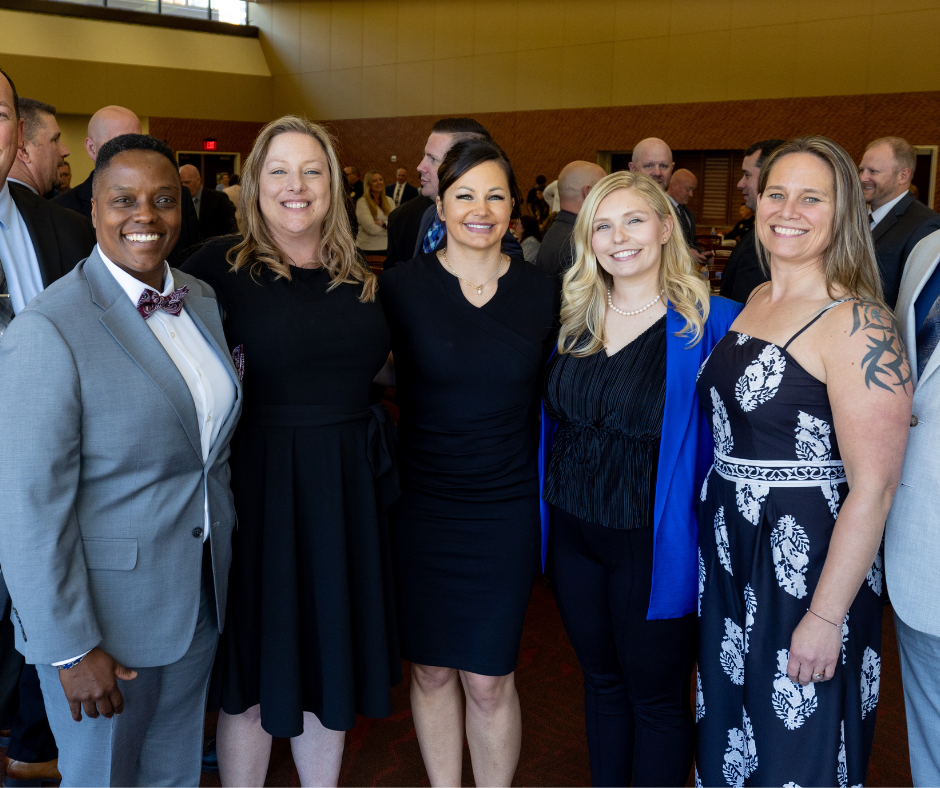 Five Command College graduates pose for a photo after graduating