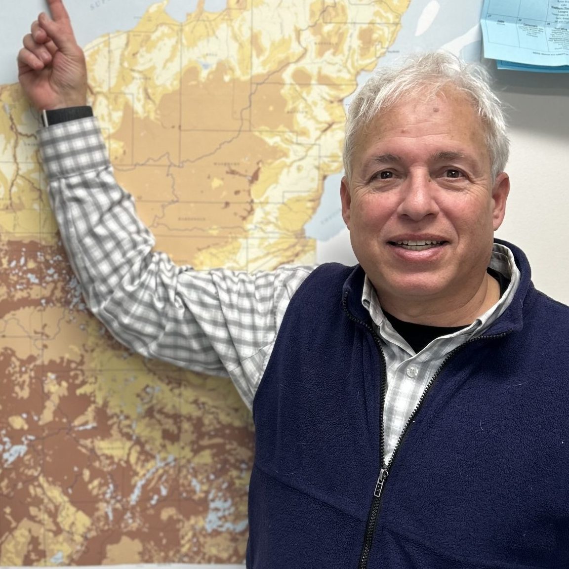 County administrator points to a Groundwater Susceptibility map on the wall