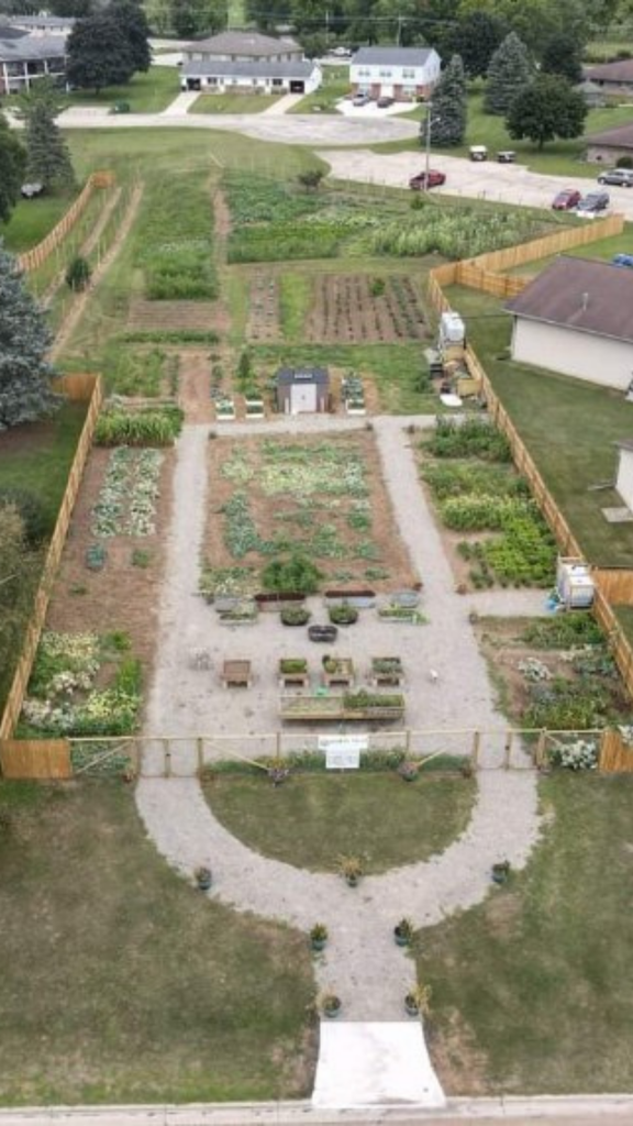 Overhead view of community garden showing pathways between beds of plants