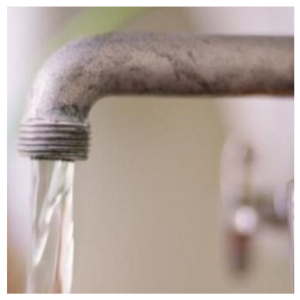 A close up photo of a faucet with water coming out