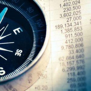 Image of compass sitting on a spread sheet