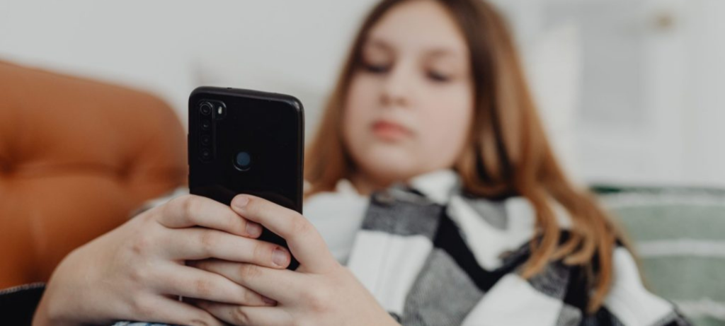 Teen looks at their phone