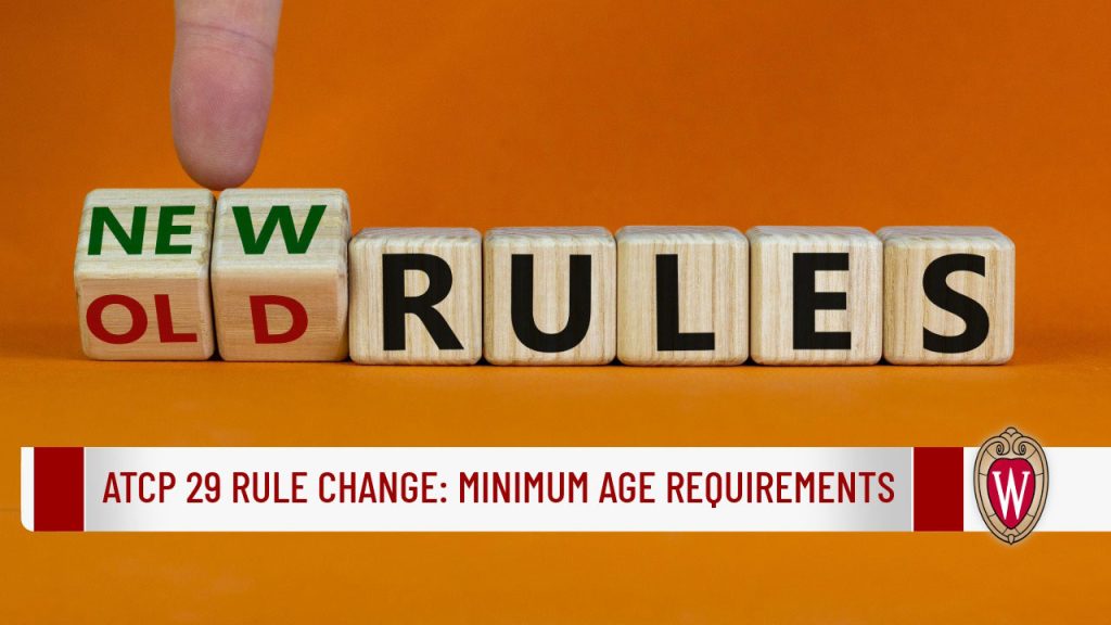 Wooden blocks spelling "OLD/NEW RULES" with a finger flipping the first cube, alongside banner text "ATCP 29 Rule Change: Minimum Age Requirements" and the UW–Madison crest.