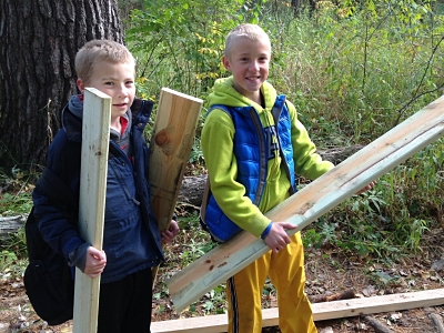 Two boys holding deck boards