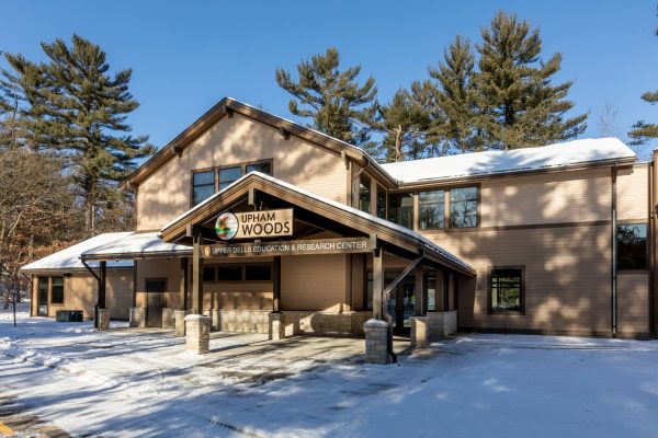 This image shows the Upper Dells Education and Research Center covered in snow.