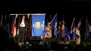 George Koepp, Columbia Co., 2018-19 WI President presenting the WI flag at the opening ceremony